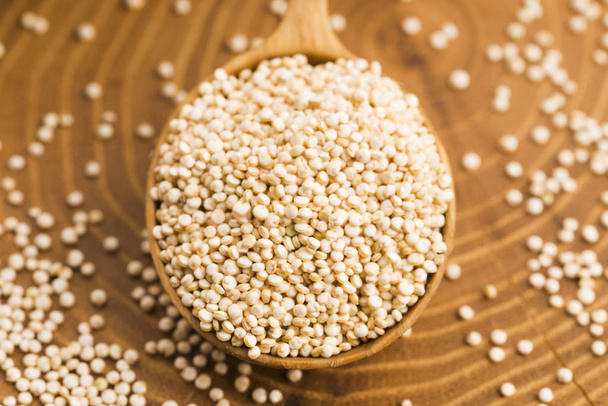 White quinoa seeds on a wooden background - Zdjęcie, obraz