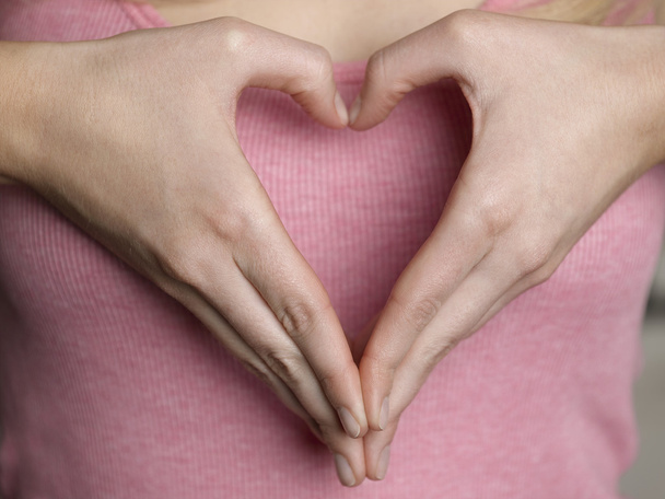 Woman Forming Heart Shape with Hands - Foto, Imagen