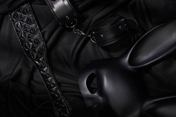 top view of sex toys on black textile background - Fotografie, Obrázek