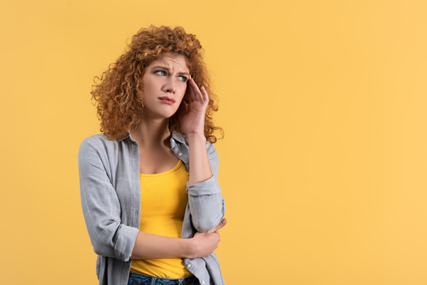 frustrated redhead young woman, isolated on yellow - Фото, зображення