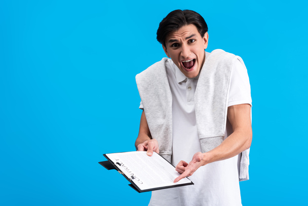 angry yelling man holding clipboard with contract, isolated on blue  - Photo, Image