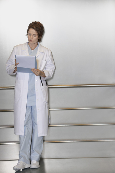 Physician Reviewing Notes in elevator - Foto, Imagem