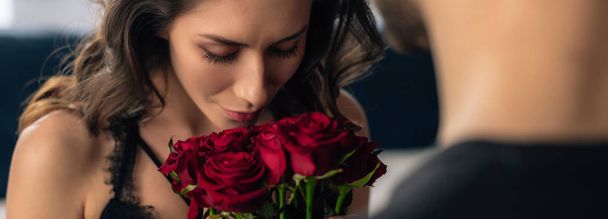 panoramic shot of attractive girlfriend smelling roses in 14 february - Fotó, kép