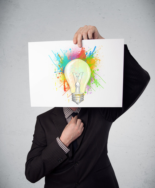 podnikatel držící lepenky s barvou šplouchá a lightbul - Fotografie, Obrázek