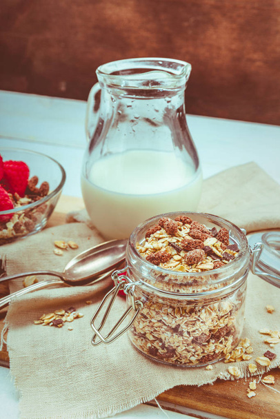granola in a jar with raspberries and milk - Zdjęcie, obraz