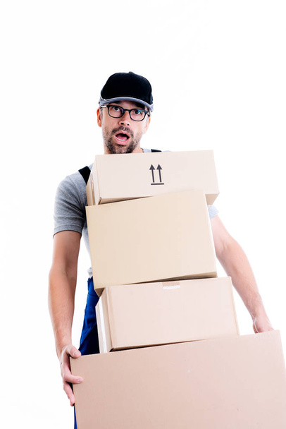 overstrained postman with parcels in front of white background - Foto, immagini