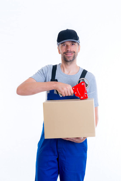 friendly postman with parcels in front of white background - Fotoğraf, Görsel
