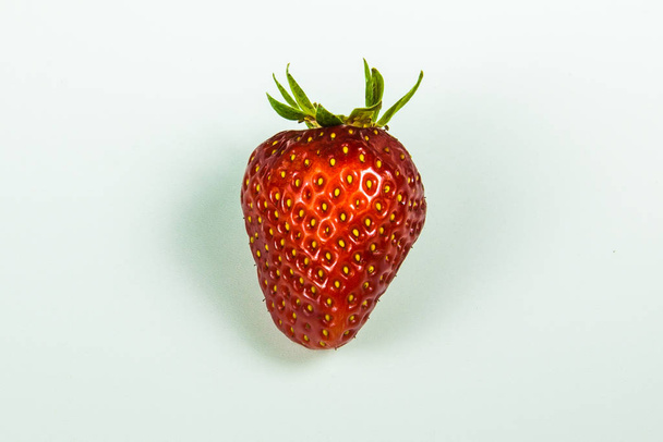 Juicy red strawberry on a white table - Foto, afbeelding