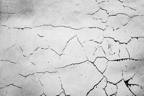 textura betonové stěny s prasklinami a škrábanci, které lze použít jako pozadí - Fotografie, Obrázek