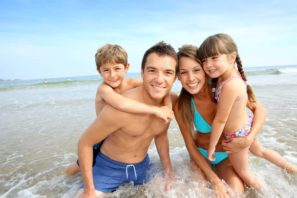 Family having fun at the beach - Fotó, kép