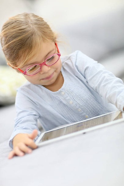 Cute little girl playing with digital tablet - Фото, зображення