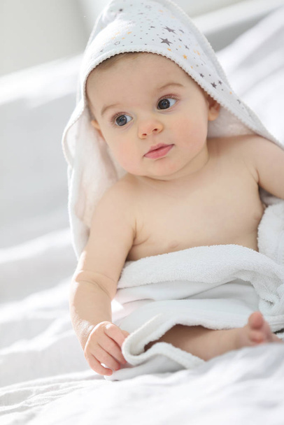 Baby boy withbath towel over him - Photo, image