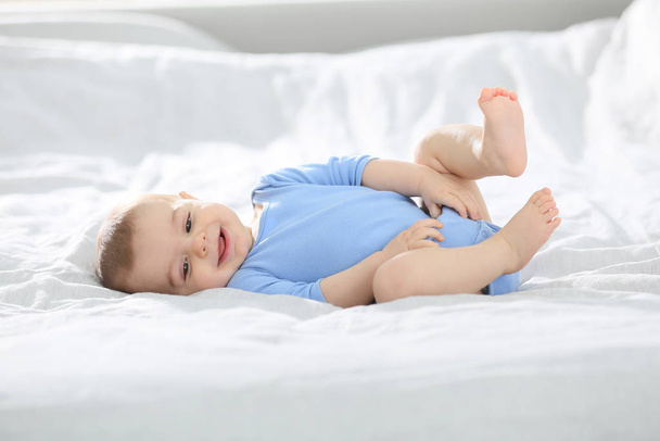 8-month-old baby boy laying on bed - Фото, зображення