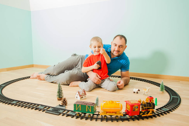 Excited father and child playing with train - Fotoğraf, Görsel