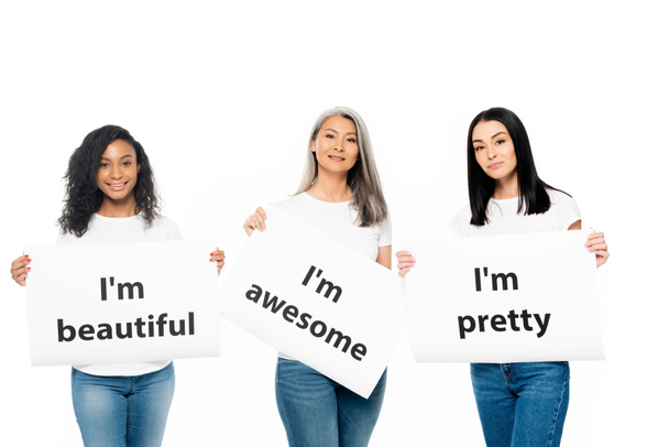 happy multicultural women holding posters with lettering isolated on white  - Photo, Image