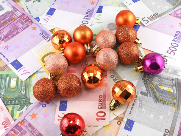 Euro notes with christmas balls on it - Фото, изображение