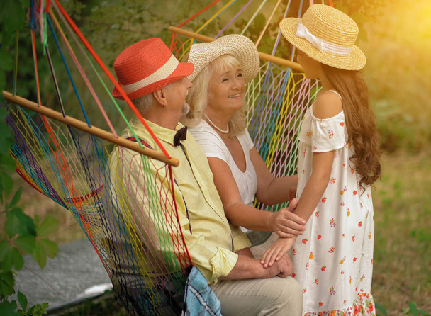 The Grandparents And Granddaughter In The Garden - Foto, Imagen