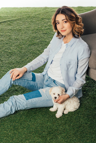 smiling woman with cute Havanese puppy sitting on grass  - Fotoğraf, Görsel