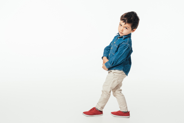 cute boy in denim shirt looking at camera isolated on white  - Fotoğraf, Görsel