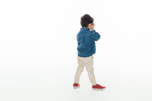 back view of boy in denim shirt on white background  - Photo, Image