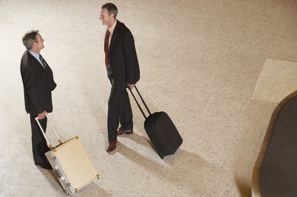 Business men with suitcases in airport - Fotó, kép