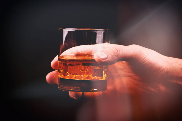Whiskey glass in a hand of a man - Photo, Image
