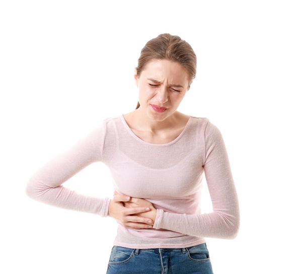 Jeune femme souffrant de maux d'estomac sur fond blanc
 - Photo, image