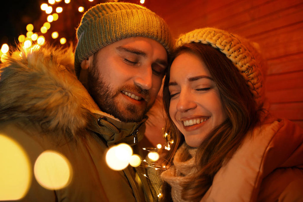 Happy couple spending time at Christmas fair - Fotoğraf, Görsel