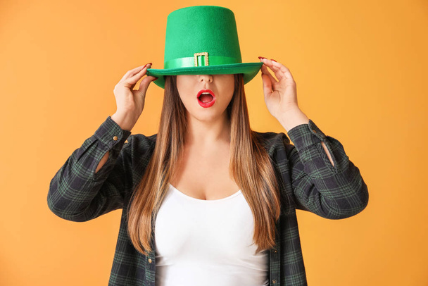 Funny young woman on color background. St. Patrick's Day celebration - 写真・画像