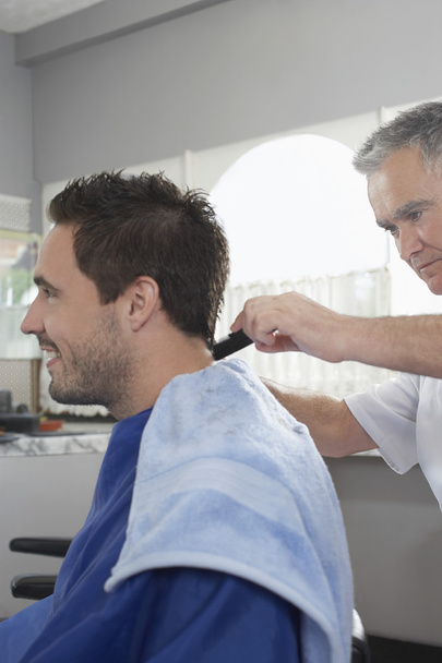 Barber cutting  hair - Фото, изображение