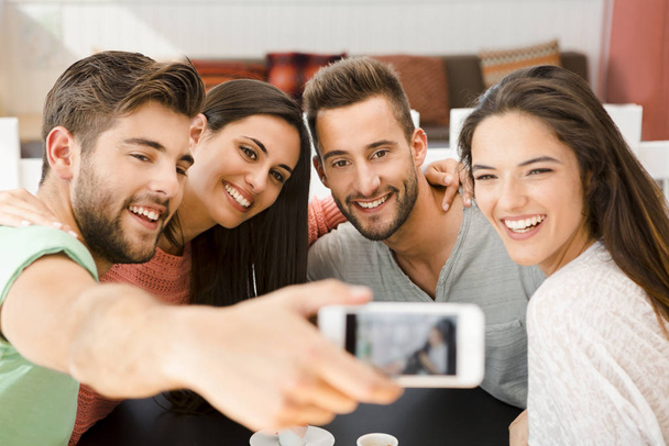 Group of friends at the coffee shop making a selfie together - Fotoğraf, Görsel