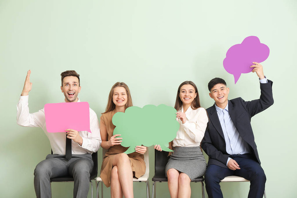 Group of business people with blank speech bubbles on color background - Photo, Image