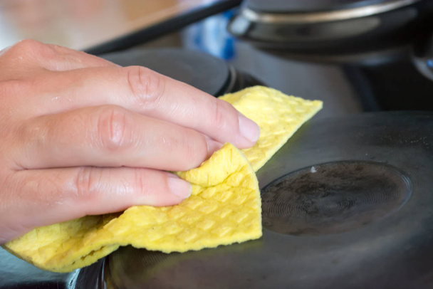 Close up of woman cleaning cooker at home kitchen - Fotoğraf, Görsel