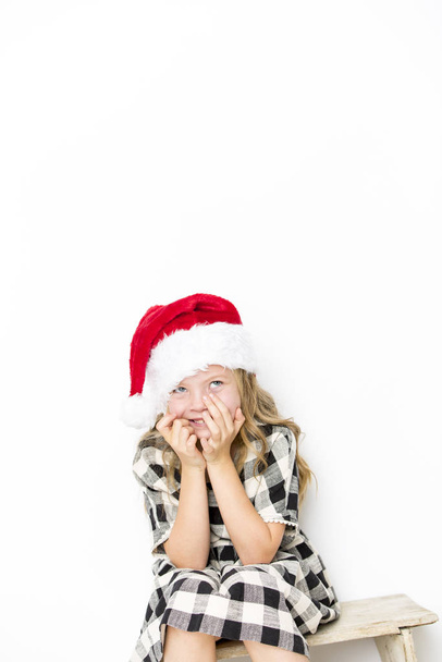 happy christmas girl in santa hat on white background - Foto, immagini