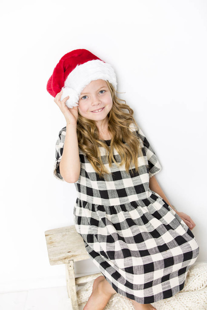 happy christmas girl in santa hat on white background - Fotografie, Obrázek