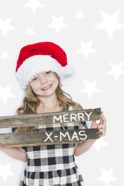 happy christmas girl in santa hat on white background - Photo, Image