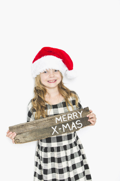 happy christmas girl in santa hat on white background - Фото, зображення