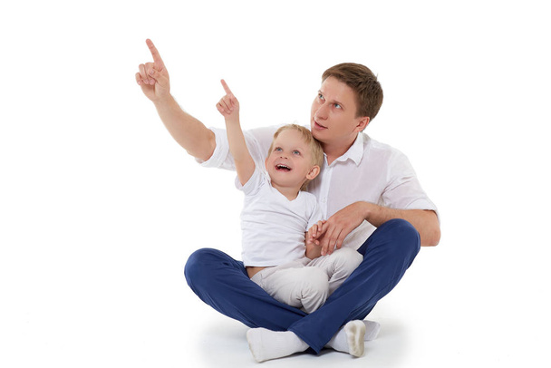 Young happy father with sweet child sit on a white background. Happy family. - Fotoğraf, Görsel