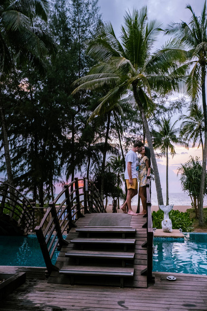 Пара дивиться захід сонця на пляжі і басейн розкішного курорту в Таїланді Хао Лак - Фото, зображення