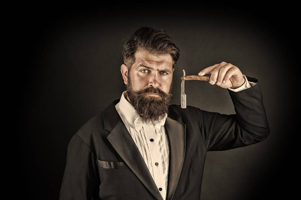 Sharp blade. Grow mustache. Growing and maintaining moustache. Man with mustache. Beard and mustache grooming. Hipster handsome bearded wear tuxedo. Barber shop concept. Shaving dangerous blade - Фото, зображення