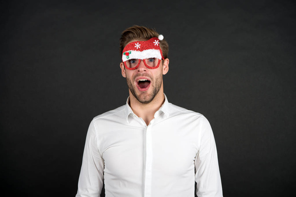 corporate party concept. business office party celebration. surprised handsome man party glasses. santa come for xmas. merry christmas. happy new year. businessman in funny santa claus glasses - Фото, изображение