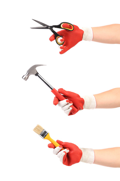 Hands holding hammer scissors and paint brush - Fotó, kép