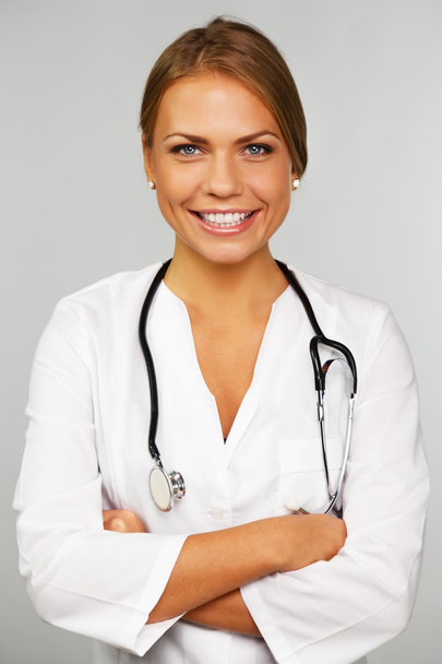 Beautiful young female doctor with stethoscope - 写真・画像