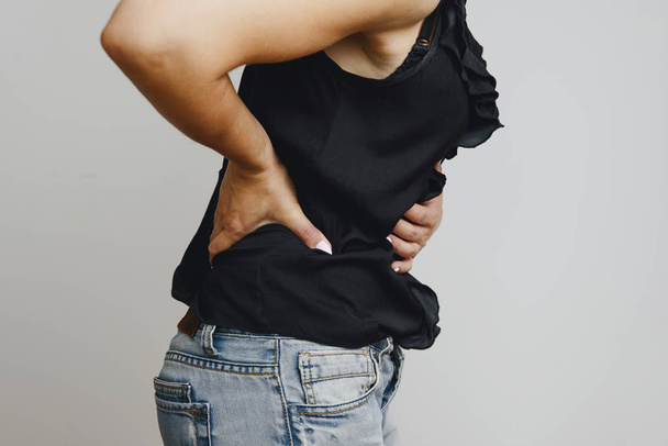 Abdominal pain in a woman. Stomach ache girls, the girl is holding her hand at the belly, suffers from pain. The woman suffers from female ailments, menstrual pain. - Fotó, kép