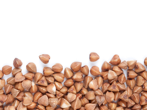 Background of buckwheat with copy space. Isolated one edge. Top view or flat lay. Healthy food and diet concept - Photo, image