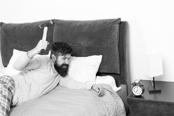 life routine. Healthy sleep concept. bearded man hipster want to sleep. hate noise of alarm clock. Irritated guy destroy annoying clock. Man awake unhappy with alarm clock ringing. Sleep longer - Zdjęcie, obraz