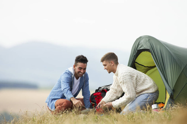 Two Young Men On Camping Trip In Countryside - Φωτογραφία, εικόνα