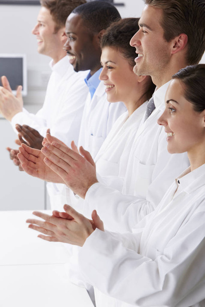 Technician And Colleagues In Laboratory Clapping - Foto, afbeelding