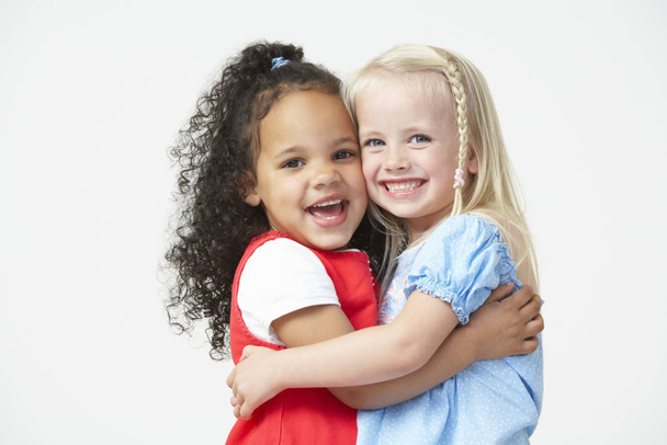 Two Pre School Girls Hugging One Another - Фото, изображение