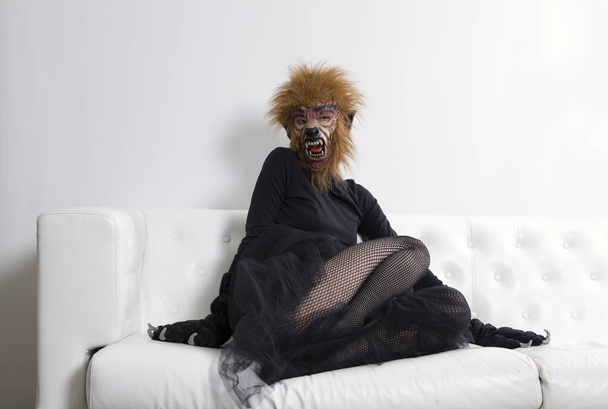 werewolf woman wearing a tutu and sitting on a white sofa - Φωτογραφία, εικόνα